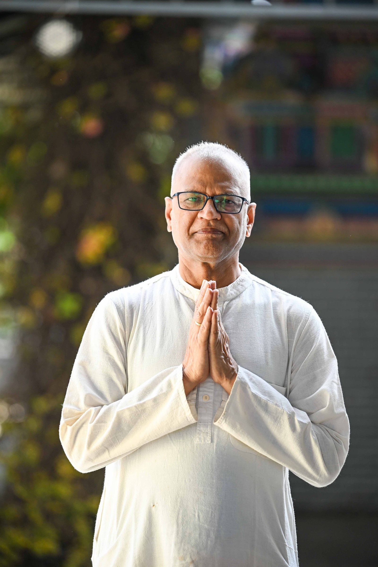 Rajesh Anand standing with hands folded in prayer