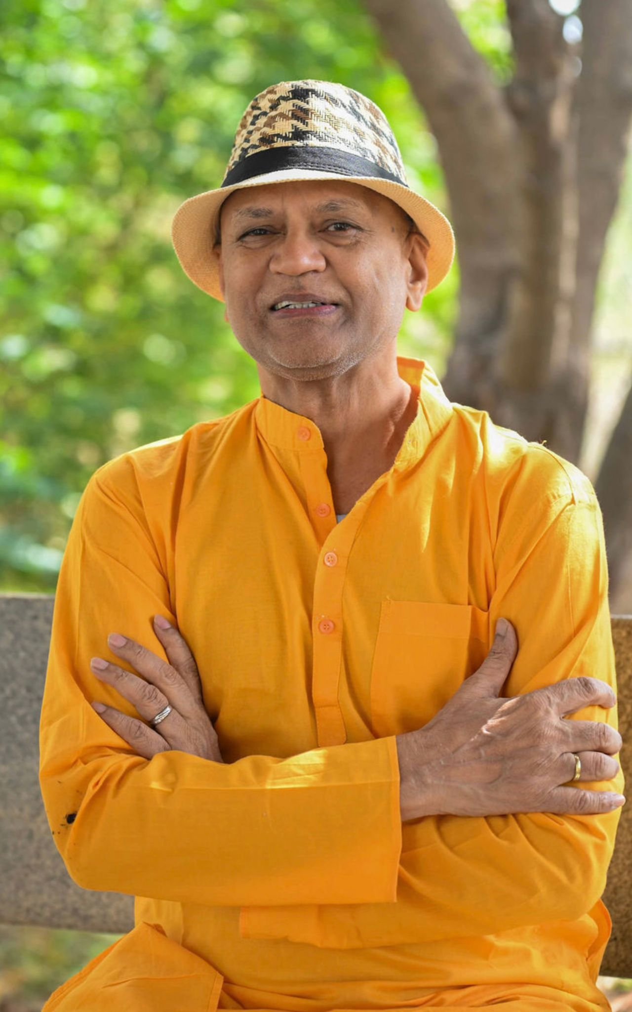 Rajesh Anand in saffron robes among the trees